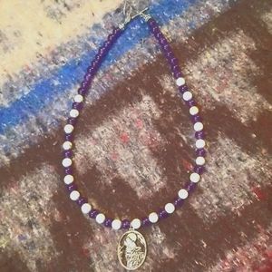 Amathyst and white turquoise beaded necklace with wolf charm. Length 15 in.